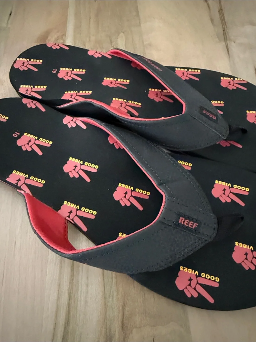 Reef Black Flip Flops with Red and Yellow Graphic Print